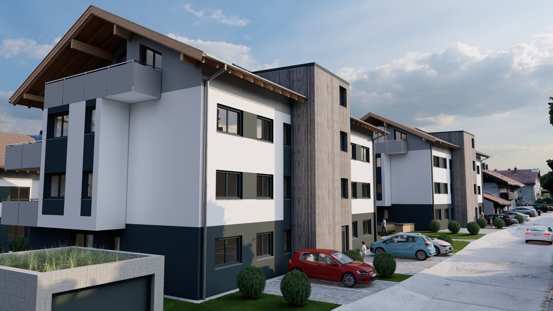 Straßenansicht der Wohnanlage mit modernen Fassaden und Parkplätzen